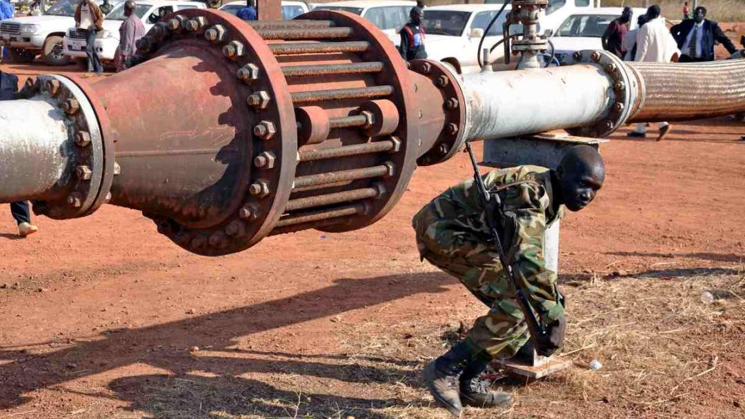 An armed member of the South Sudanese security forces is seen during a ceremony marking the restarting of crude oil pumping at the Unity oil fields in South Sudan on January 21, 2019. 